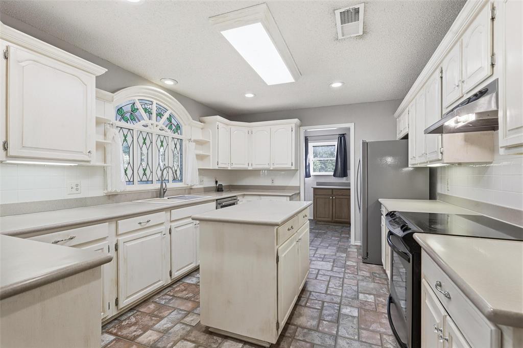 6140 Dick Price Road Fort Worth, TX 76140 - Photo 10 of 40 a kitchen with a sink stove and cabinets