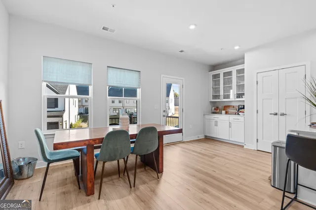 a view of a dining room with furniture and wooden floor