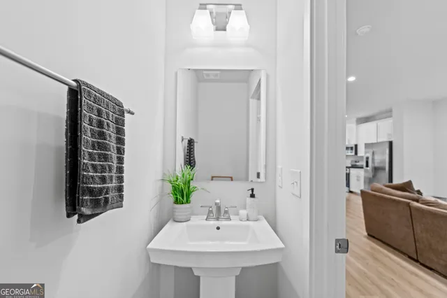 a bathroom with a sink a mirror and a shower