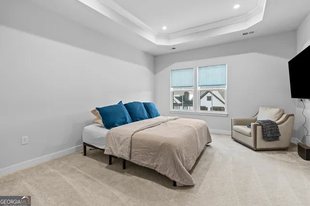 a bedroom with a bed and a television