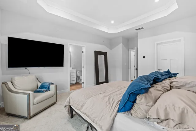 a bedroom with a bed and a flat screen tv