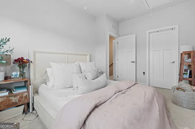 a large white bed in a white room