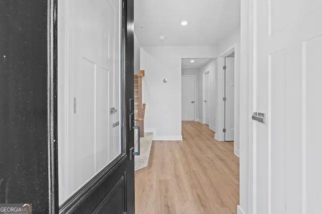 a view of a hallway with wooden floor
