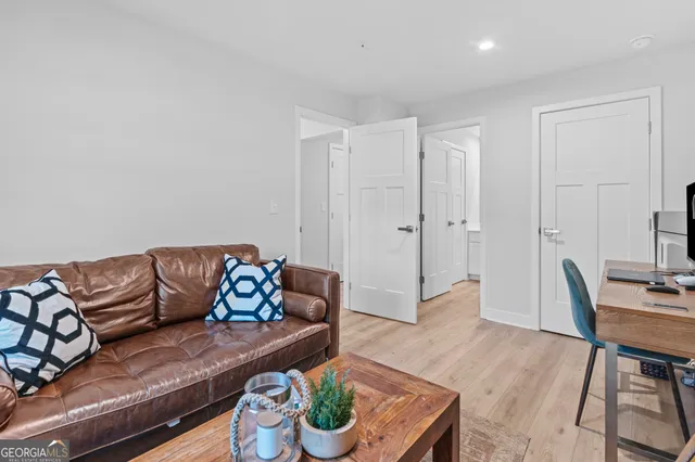 a living room with furniture and a wooden floor
