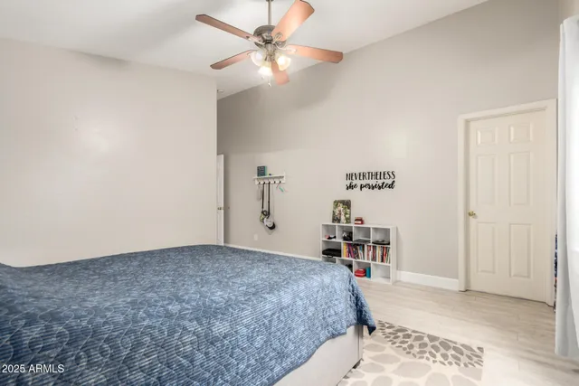 a bedroom with a bed and a chandelier