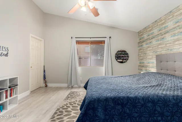 a bedroom with a bed and a window