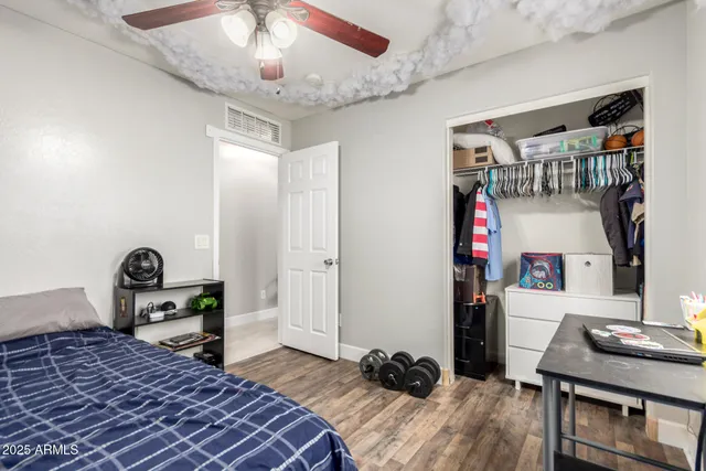 a bedroom with furniture and a wooden floor