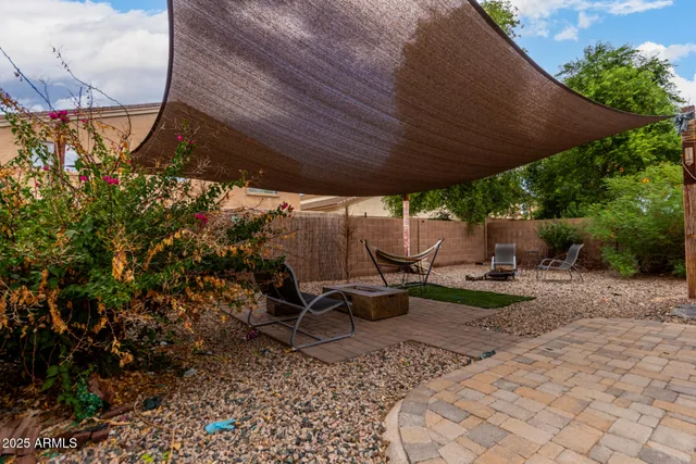a view of a backyard with sitting area
