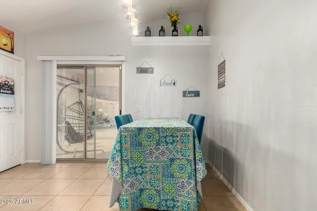 a dining room with furniture and a window