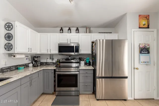 a kitchen with stainless steel appliances a refrigerator sink and microwave