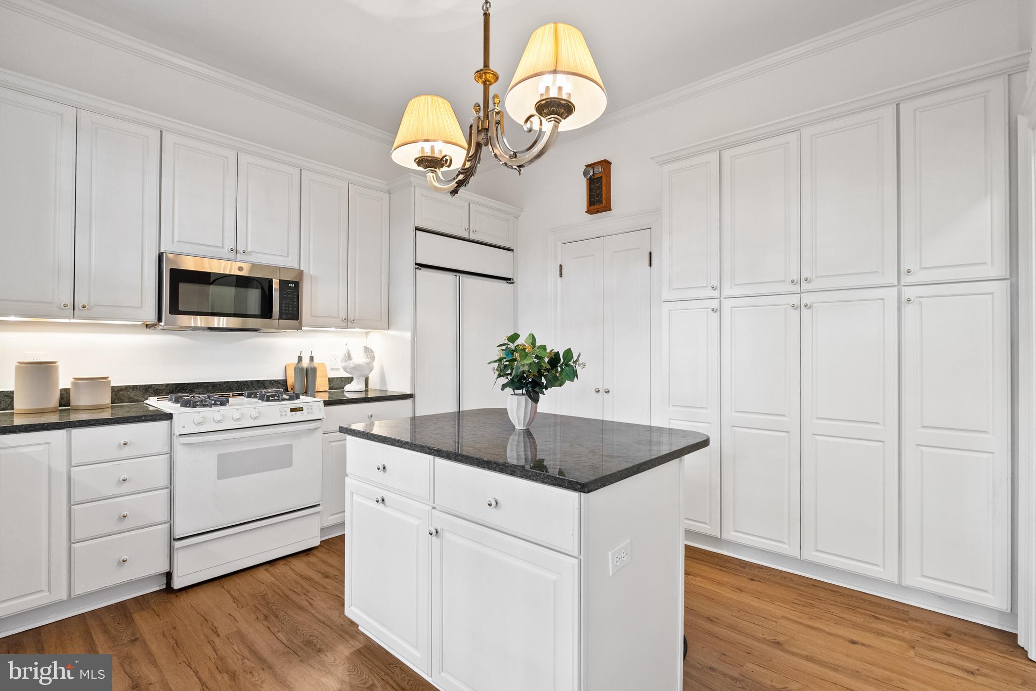 2125 Bancroft Place Northwest Washington, DC 20008 - Photo 18 of 48 a kitchen with white cabinets and stainless steel appliances