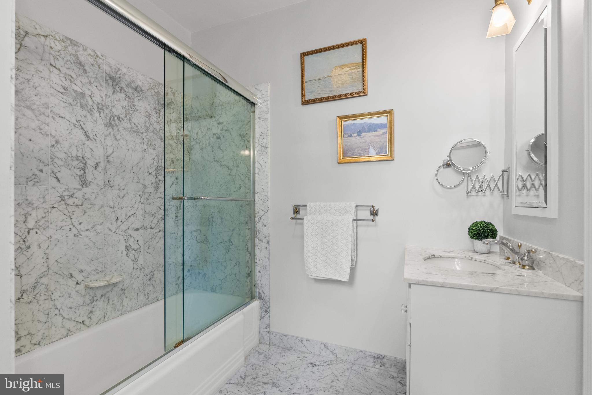 2125 Bancroft Place Northwest Washington, DC 20008 - Photo 29 of 48 a bathroom with a granite countertop sink a mirror and shower