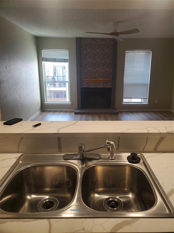 5532 Boca Raton Boulevard, Unit 290 Fort Worth, TX 76112 - Photo 8 of 16 Dual basin stainless steel sink with a single-handle faucet and integrated sprayer, set within a patterned countertop.