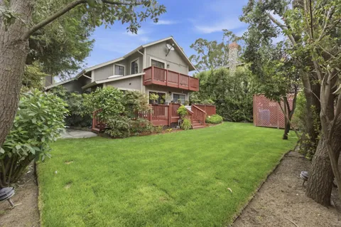 a front view of house with a garden
