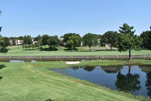 a view of a golf course with a lake view