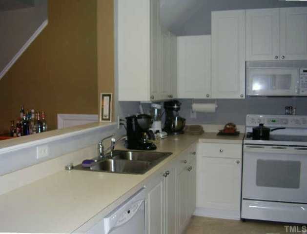 2033 Metacomet Way Raleigh, NC 27604 - Photo 3 of 8 a kitchen with a sink cabinets and stainless steel appliances