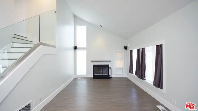 a view of a livingroom with an empty space and a fireplace