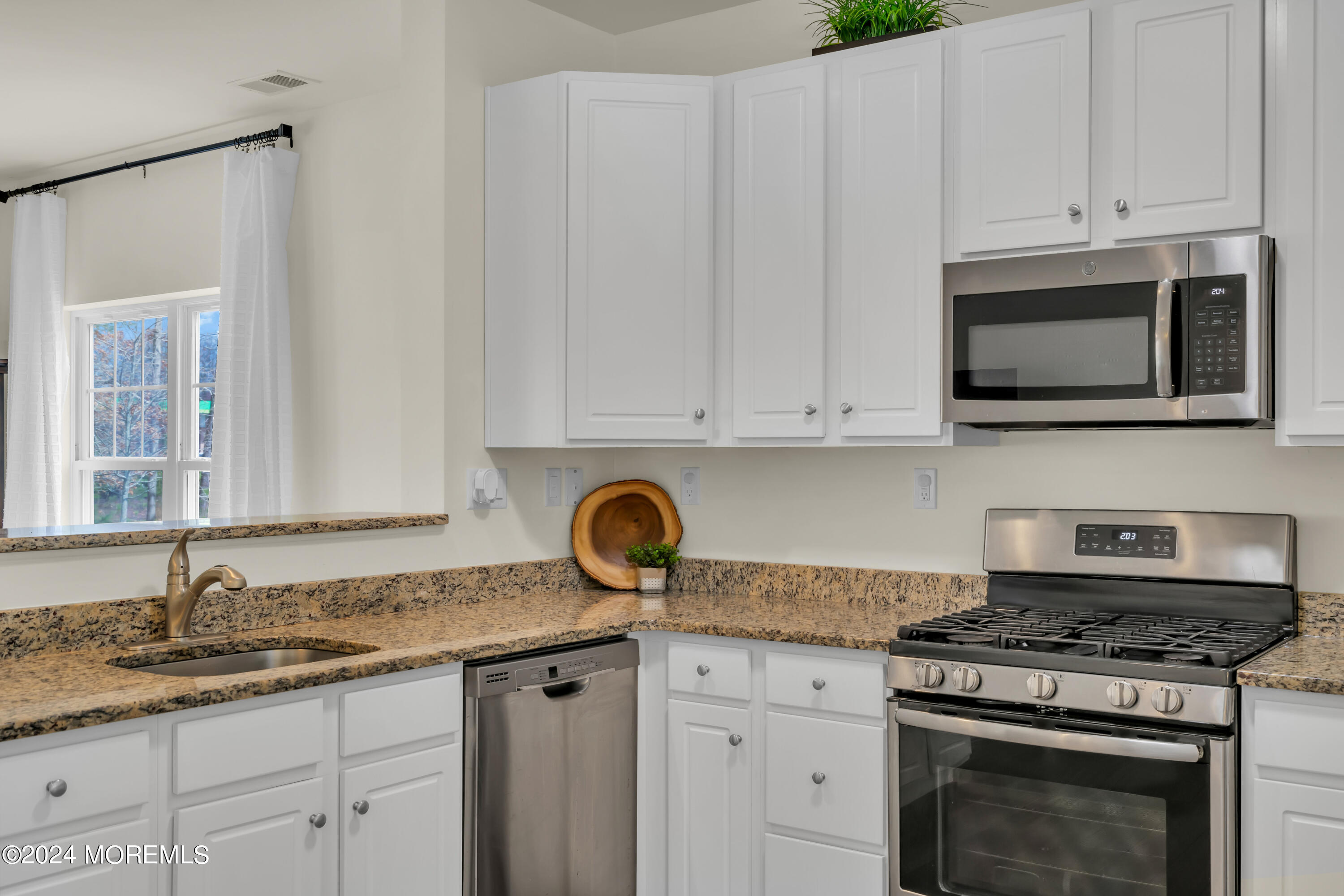 20 Rockingham Way Manchester Township, NJ 08759 - Photo 15 of 40 a kitchen with granite countertop white cabinets and appliances