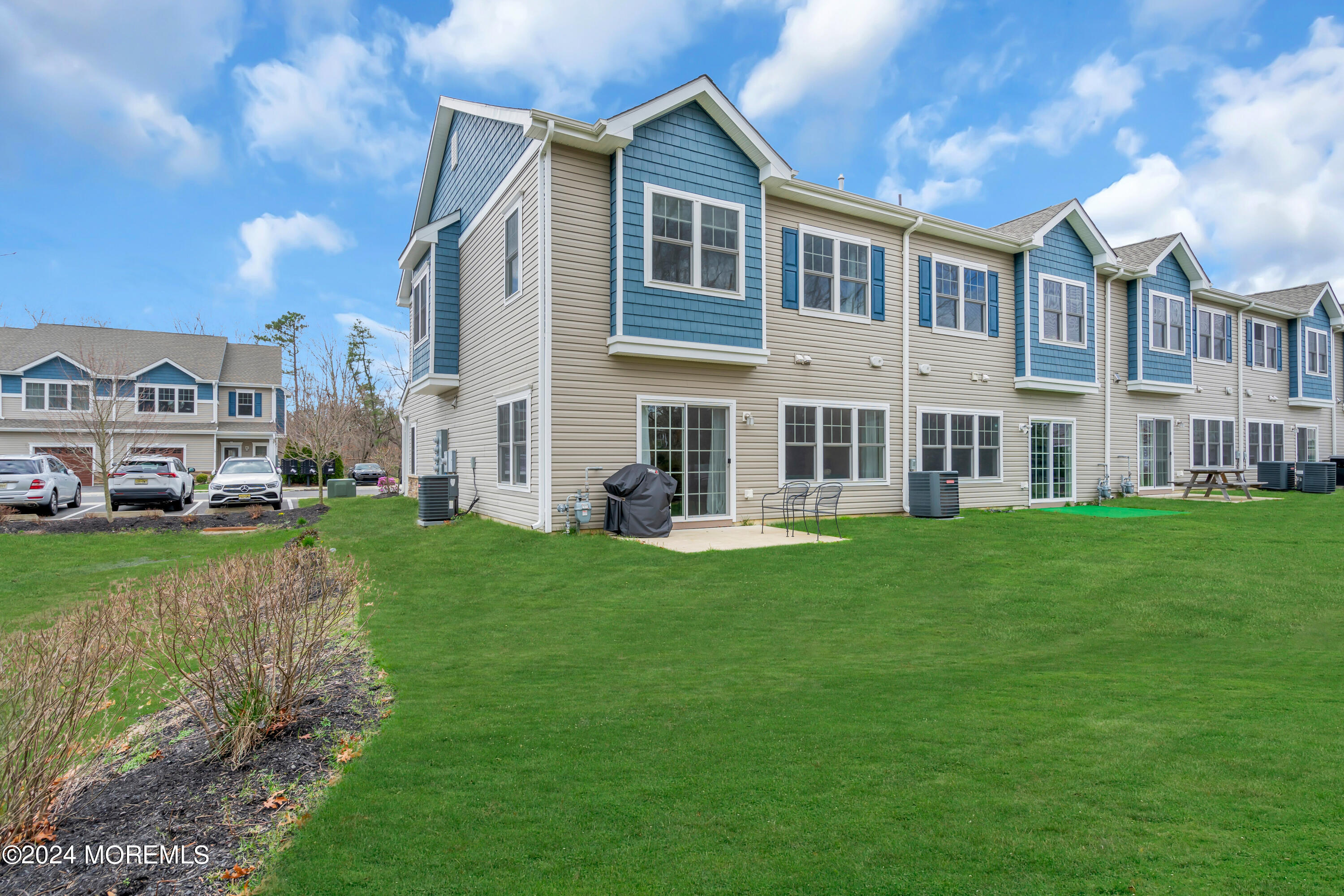 20 Rockingham Way Manchester Township, NJ 08759 - Photo 2 of 40 a front view of a house with a yard table and chairs
