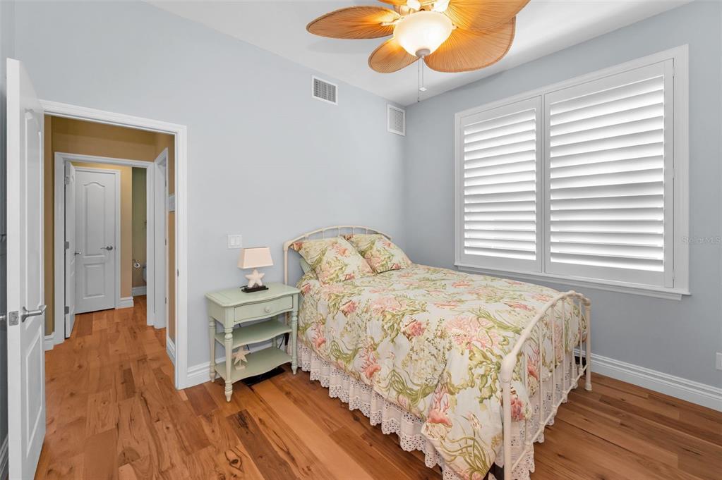 13303 Gulf Lane Madeira Beach, FL 33708 - Photo 25 of 42 a bedroom with a bed and a chandelier