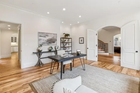 a kitchen with stainless steel appliances granite countertop white cabinets a sink and dishwasher with wooden floor