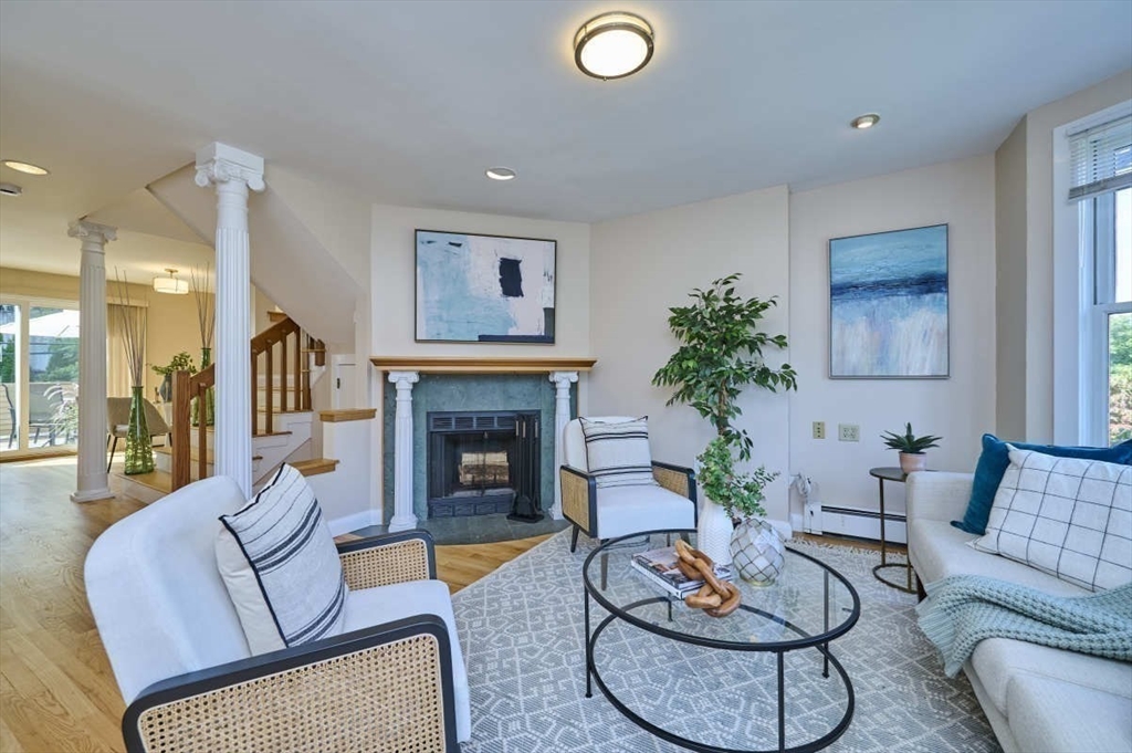 a living room with furniture potted plant and a fireplace