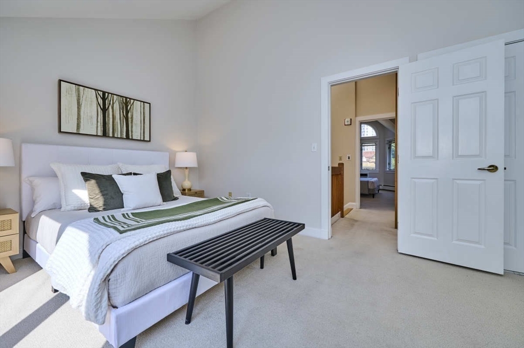 626 Washington Street, Unit 4 Brookline, MA 02446 - Photo 16 of 37 a bedroom with a bed and a table