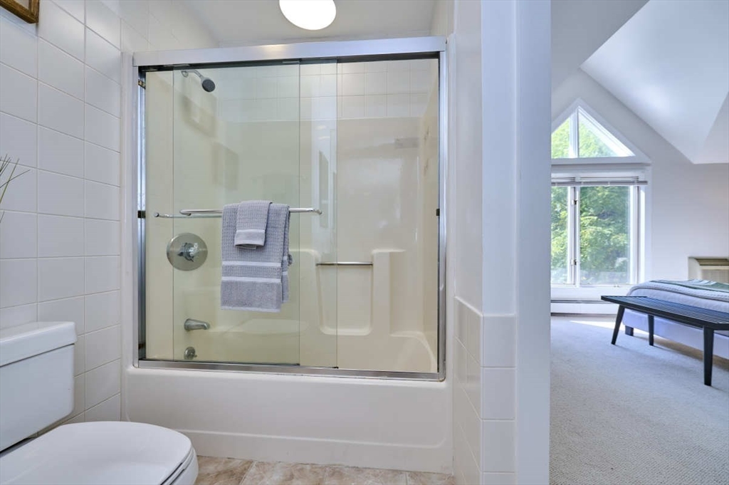 626 Washington Street, Unit 4 Brookline, MA 02446 - Photo 20 of 37 a bathroom with a shower a toilet and a window