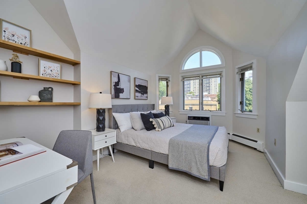 626 Washington Street, Unit 4 Brookline, MA 02446 - Photo 23 of 37 a bedroom with a bed and a window