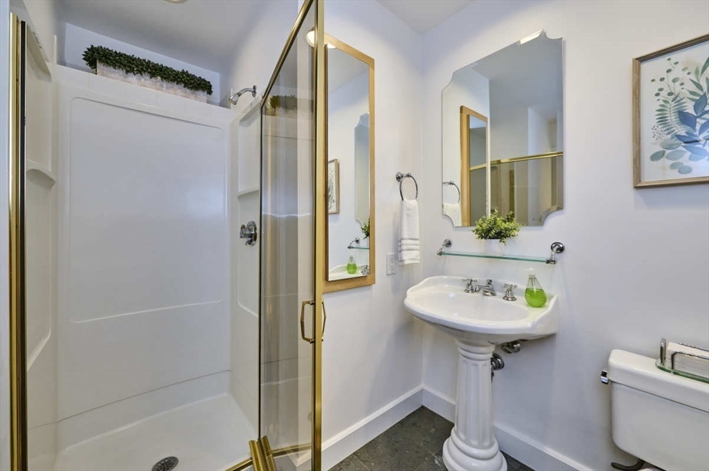 626 Washington Street, Unit 4 Brookline, MA 02446 - Photo 26 of 37 a bathroom with a sink toilet and shower