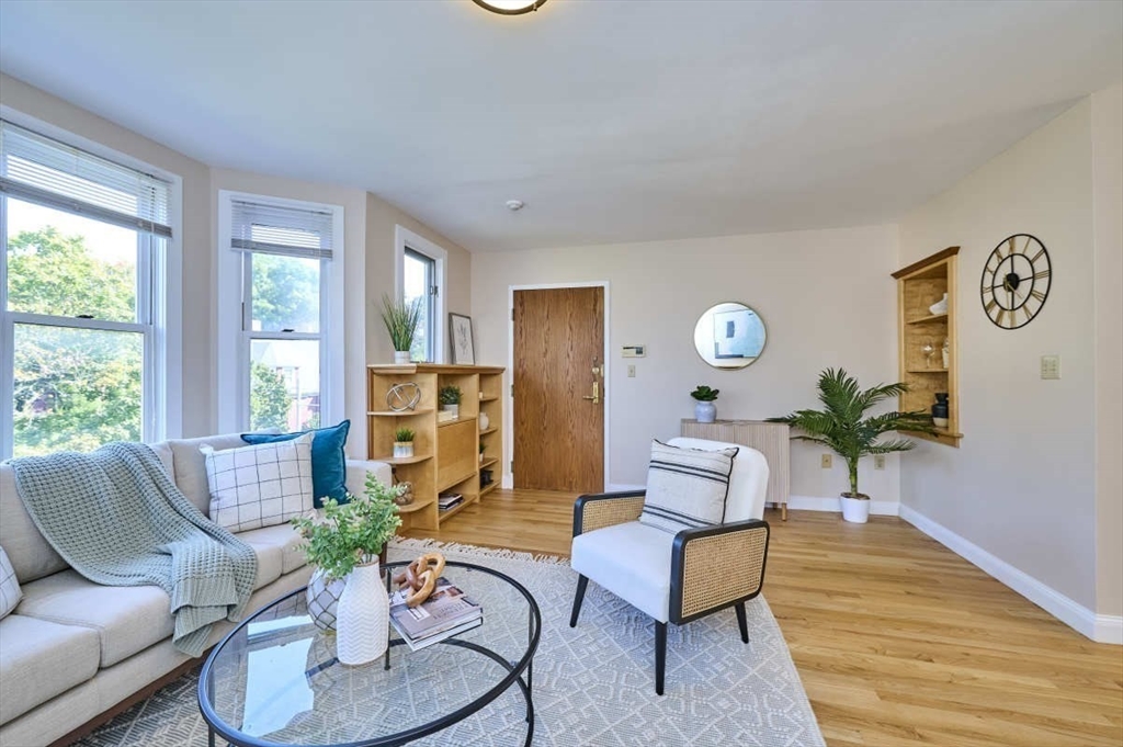 626 Washington Street, Unit 4 Brookline, MA 02446 - Photo 29 of 37 a living room with furniture and a large window