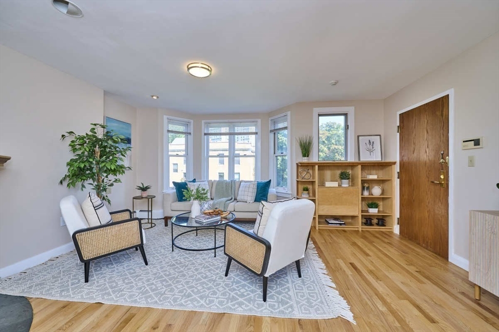 626 Washington Street, Unit 4 Brookline, MA 02446 - Photo 30 of 37 a living room with furniture and a rug
