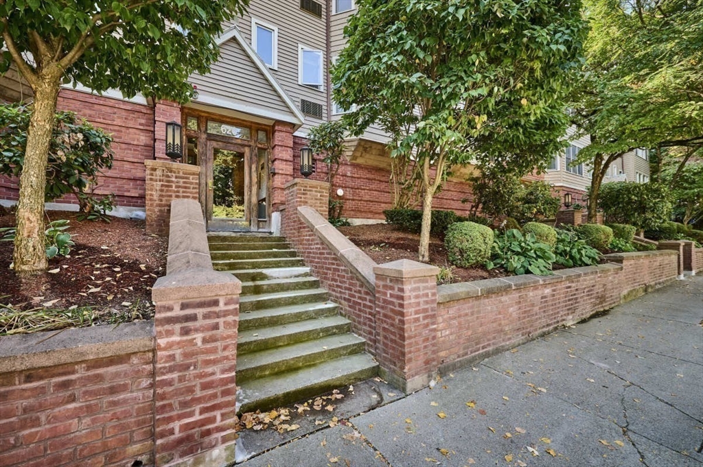 626 Washington Street, Unit 4 Brookline, MA 02446 - Photo 36 of 37 a front view of a house with a garden