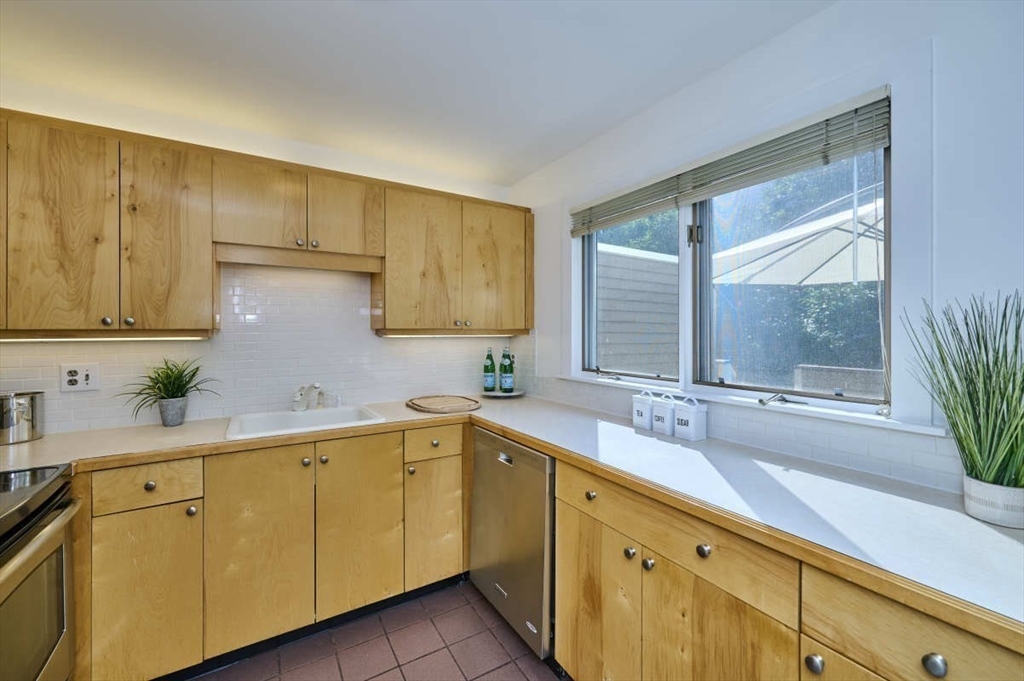 626 Washington Street, Unit 4 Brookline, MA 02446 - Photo 8 of 37 a kitchen with a sink and a window
