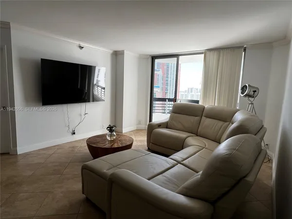 a living room with furniture and a flat screen tv