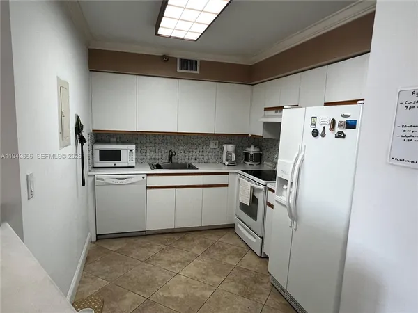 a kitchen with a refrigerator and a sink