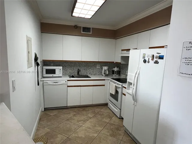 a kitchen with a refrigerator and a sink
