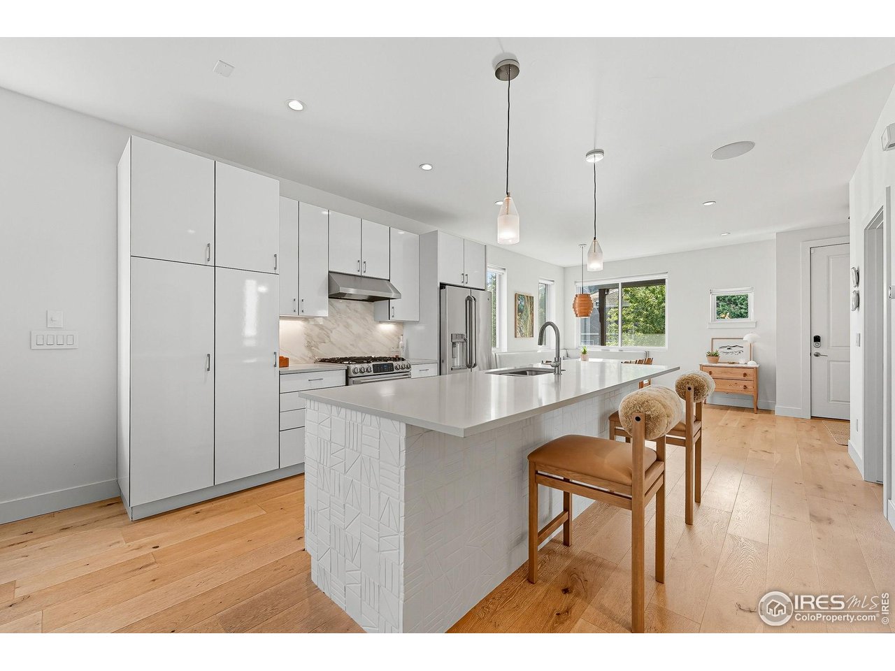 4740 8th Street Boulder, CO 80304 - Photo 11 of 50 a kitchen with stainless steel appliances granite countertop a refrigerator a sink a stove and white cabinets with wooden floor