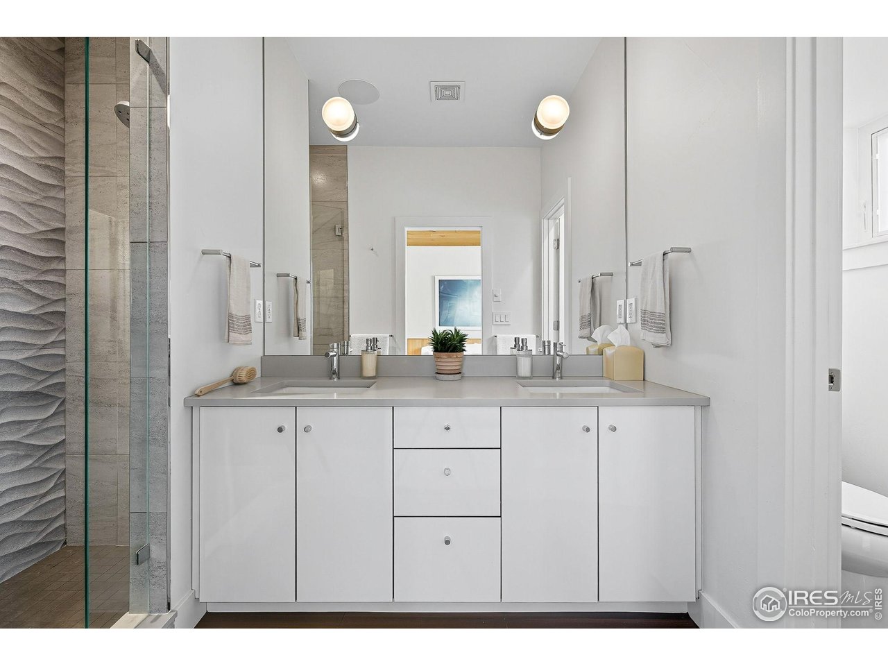 4740 8th Street Boulder, CO 80304 - Photo 27 of 50 a bathroom with a double vanity sink and a mirror