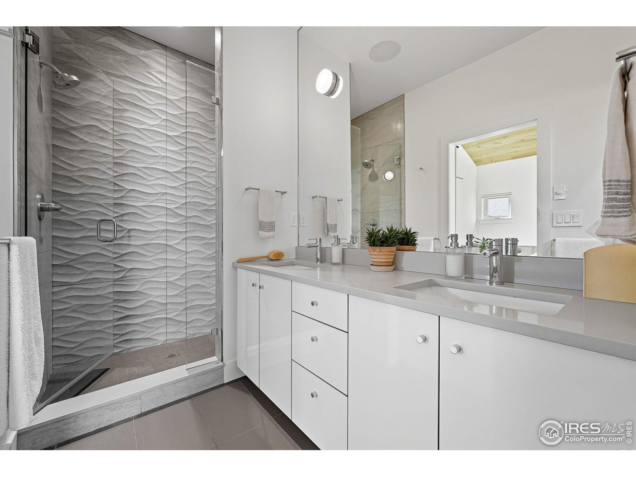 4740 8th Street Boulder, CO 80304 - Photo 28 of 50 a bathroom with a double vanity sink and a mirror