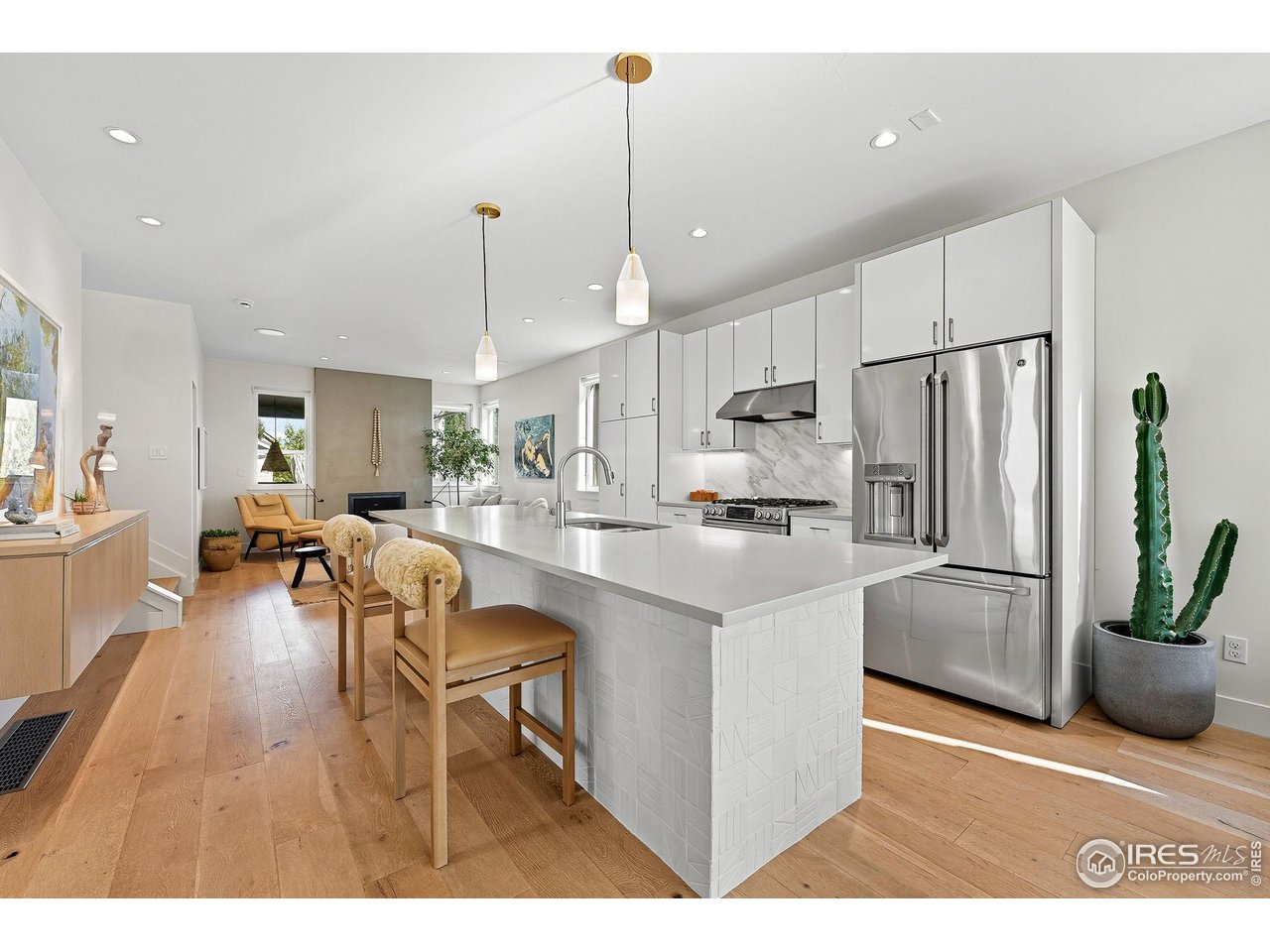 4740 8th Street Boulder, CO 80304 - Photo 6 of 50 a kitchen with stainless steel appliances kitchen island granite countertop a refrigerator a stove a sink a dining table and chairs with wooden floor