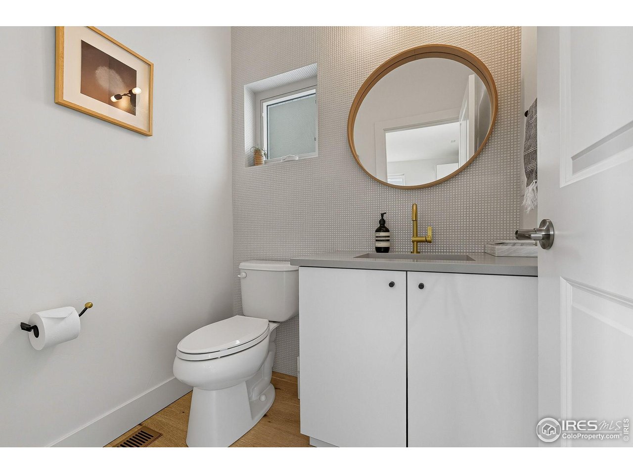 4740 8th Street Boulder, CO 80304 - Photo 8 of 50 a bathroom with a toilet a sink and a mirror