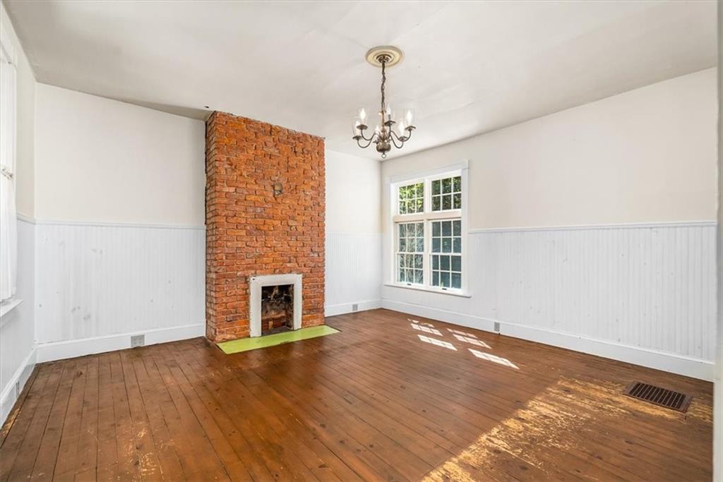 4104 Ben Miller Road Gibsonia, PA 15044 - Photo 12 of 38 a view of an empty room with wooden floor fireplace and a window