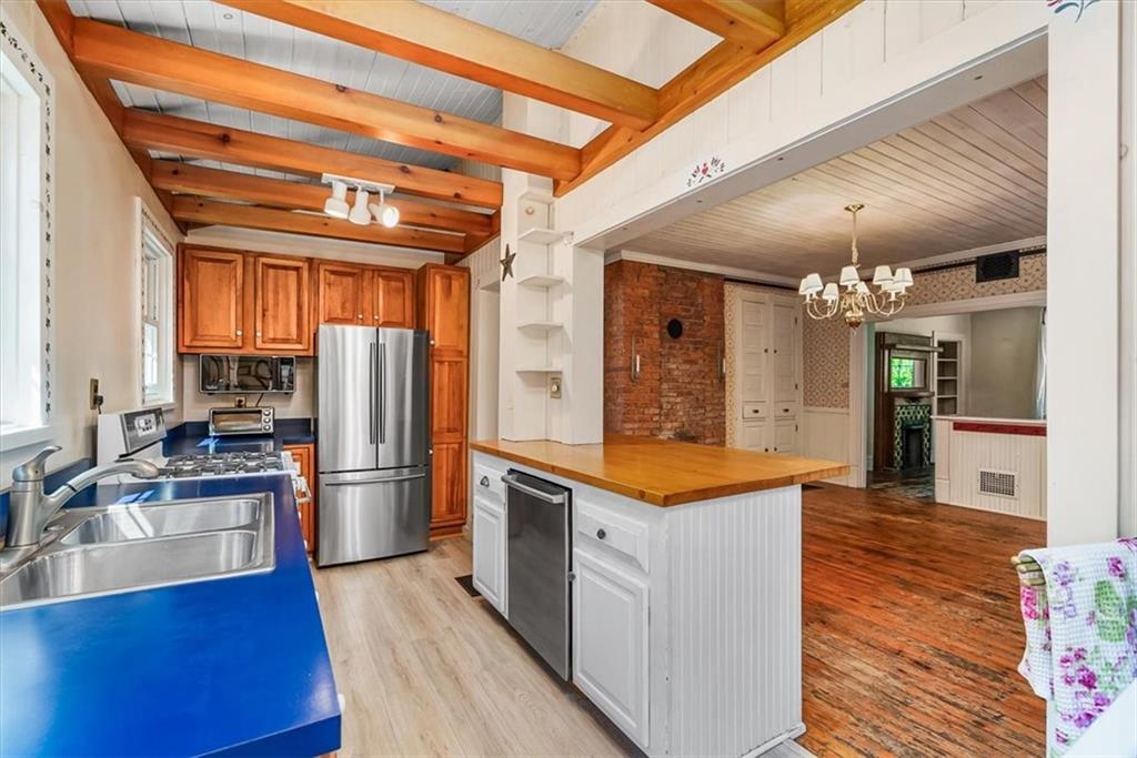 4104 Ben Miller Road Gibsonia, PA 15044 - Photo 14 of 38 a kitchen with stainless steel appliances granite countertop a refrigerator a stove and a wooden floors