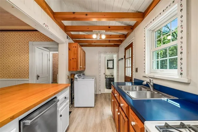 a kitchen with stainless steel appliances granite countertop a sink stove and cabinets