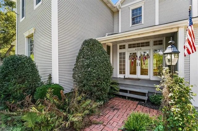 a view of house with a window and potted plants