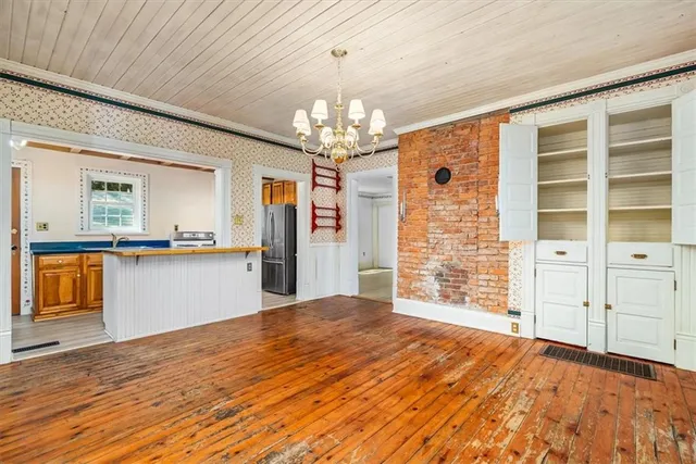 a view of an empty room with cabinet and a window