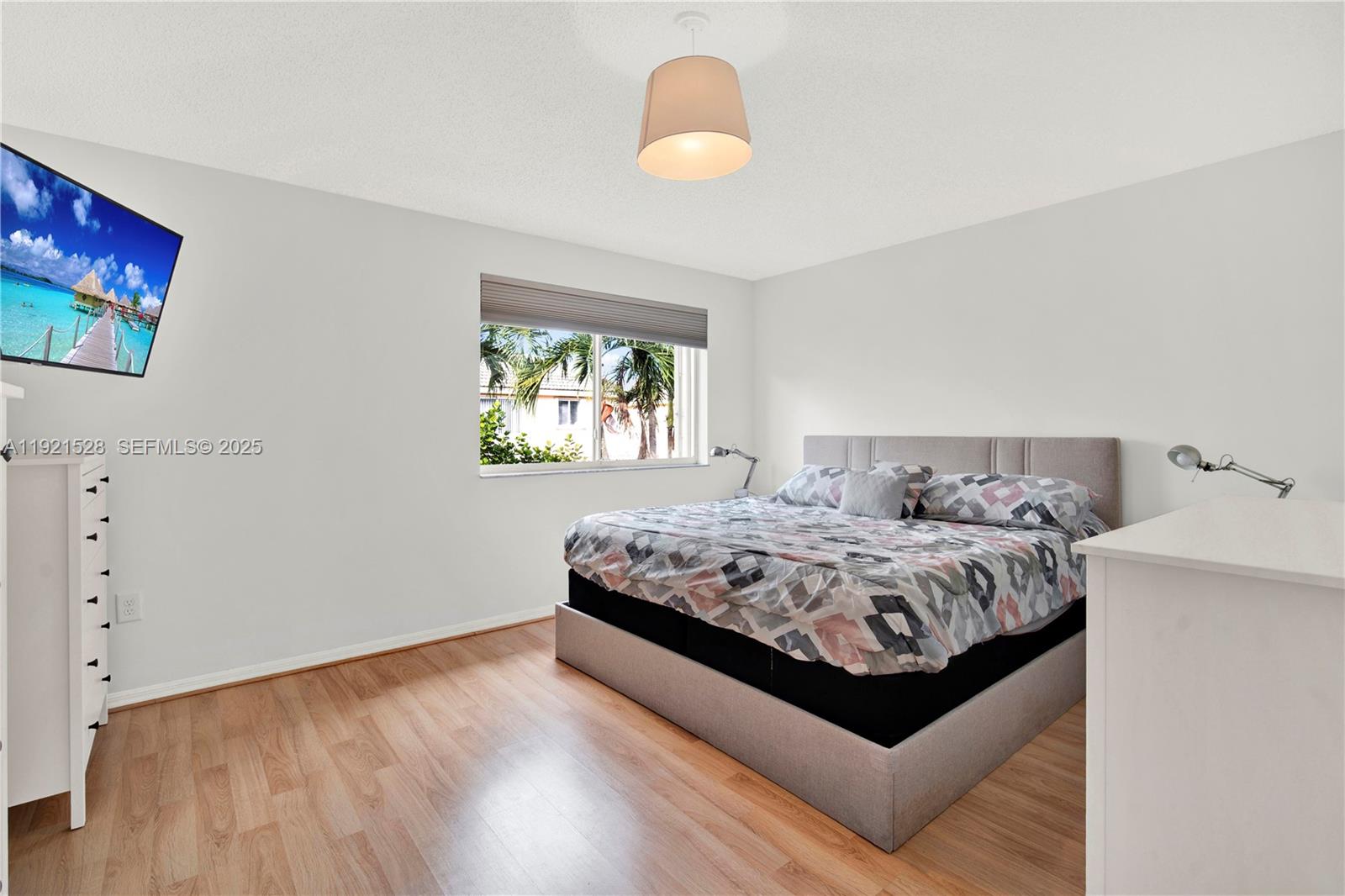 16415 Southwest 73rd Terrace Miami, FL 33193 - Photo 26 of 41 a bedroom with a bed and a chandelier