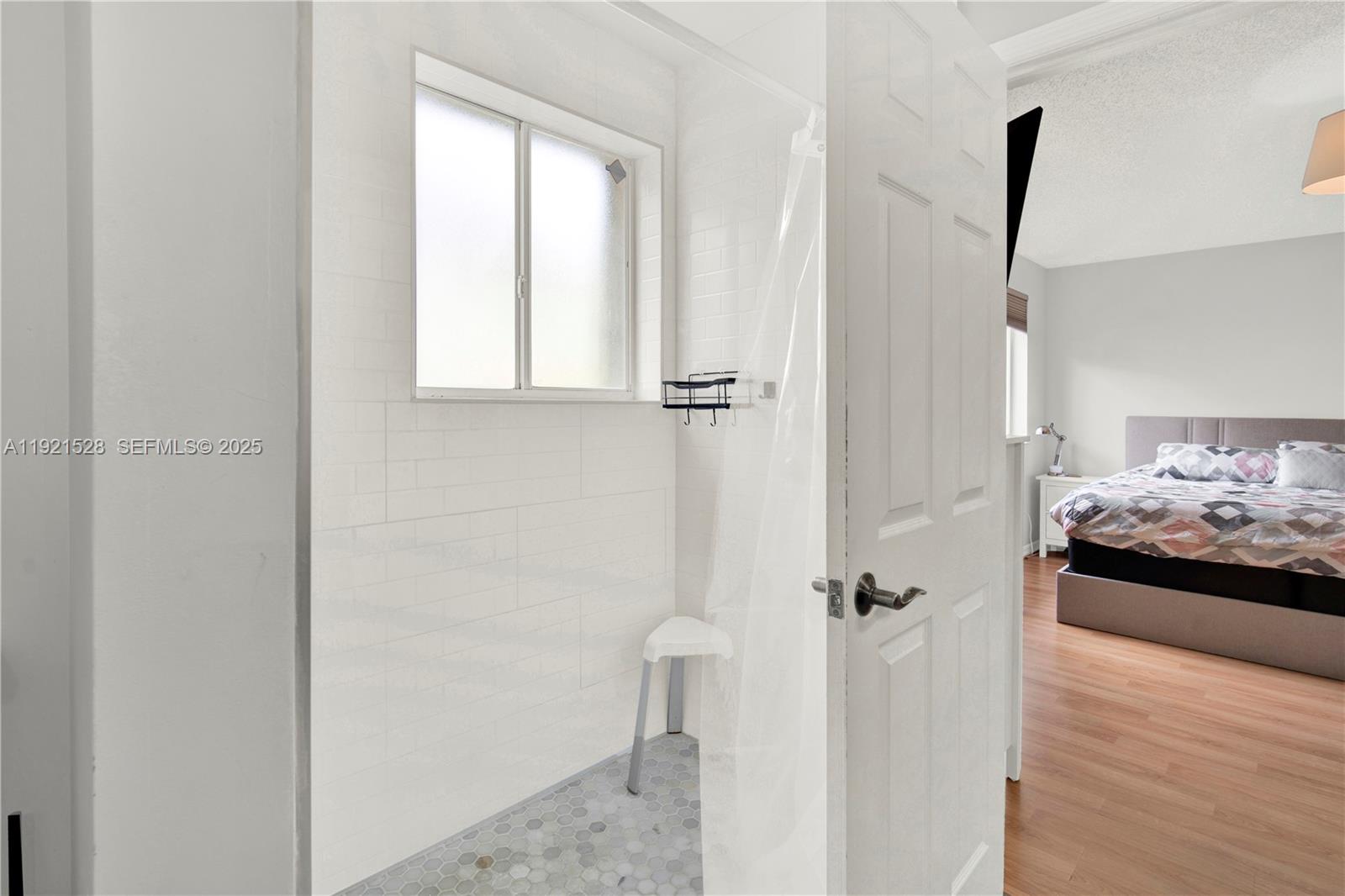 16415 Southwest 73rd Terrace Miami, FL 33193 - Photo 30 of 41 a view of a bedroom with a bed and wooden floor