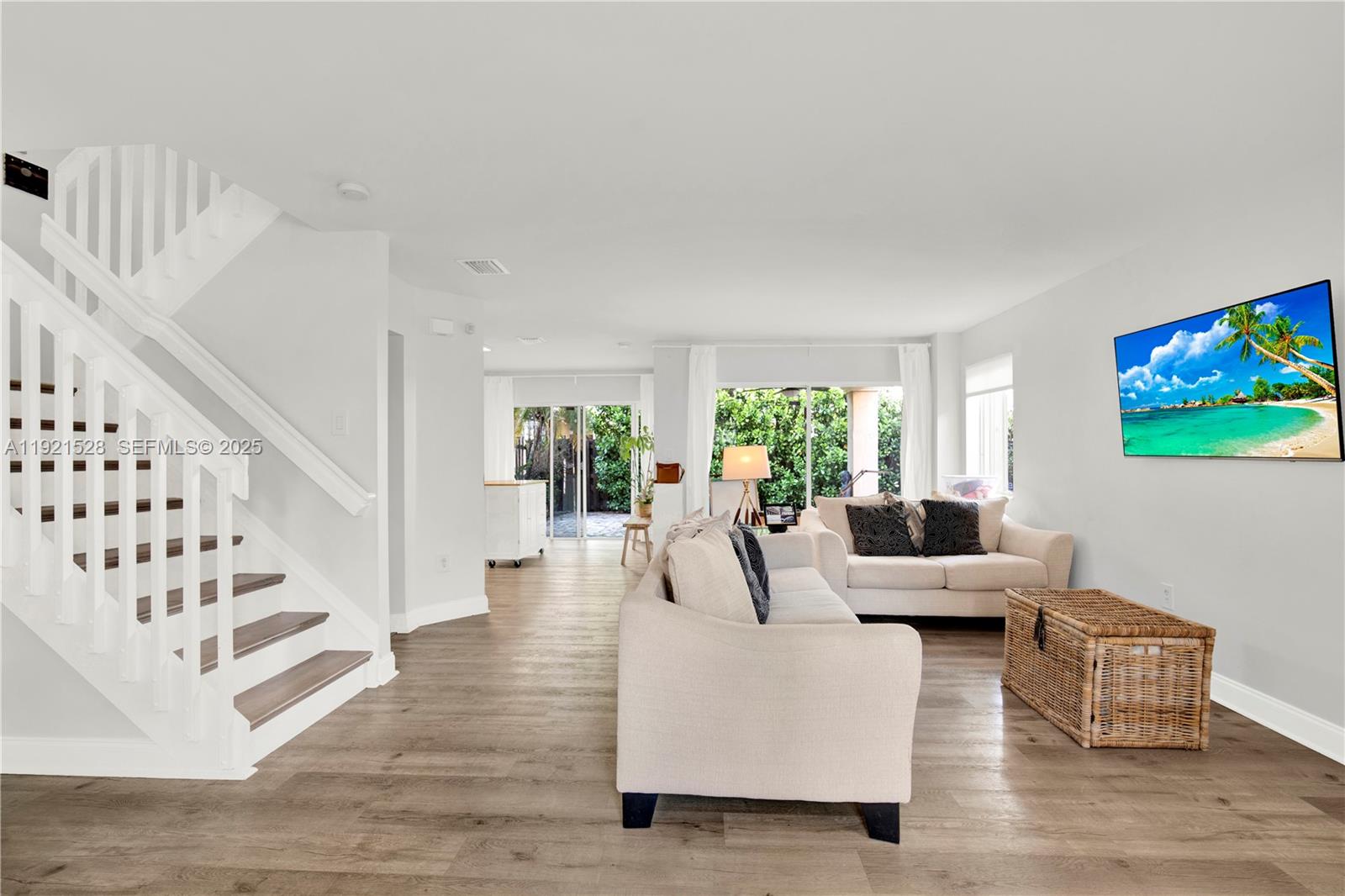 16415 Southwest 73rd Terrace Miami, FL 33193 - Photo 6 of 41 a living room with furniture and stairs with wooden floor